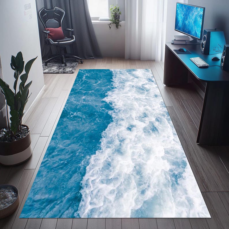 May include: A rectangular rug featuring a vibrant ocean wave design. The rug showcases a dynamic blend of deep blue and white, creating a realistic water effect. The rug is placed on a wooden floor.