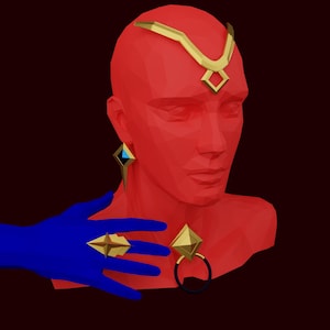 May include: A red bust sculpture with gold geometric jewelry, including a headband, earrings, a ring, and a necklace. The bust is wearing a blue glove on one hand.