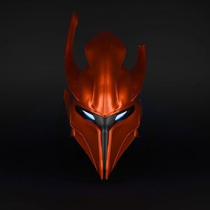 May include: A red and black helmet with a pointed top and glowing blue eyes. The helmet is made of a smooth, metallic material.