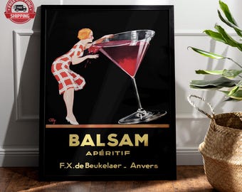 May include: A framed vintage advertisement for Balsam Apéritif. The artwork features a woman in a red and white dress leaning towards a large cocktail glass filled with a red liquid. The text "BALSAM APÉRITIF" is in gold lettering.