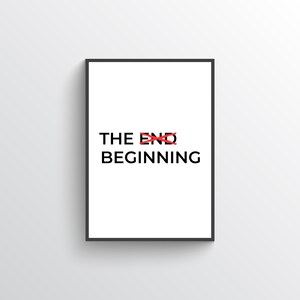 May include: A framed print featuring the words "THE END" crossed out in red, with "BEGINNING" below in black. The print has a white background and a black frame.