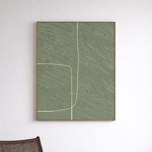 Puede incluir: Una impresión artística abstracta con un fondo verde salvia texturizado y un diseño minimalista de líneas blancas. La obra de arte está enmarcada en un marco dorado. El texto "CURIOSITY ES ART HIGH QUALITY CANVAS" está en la parte inferior.