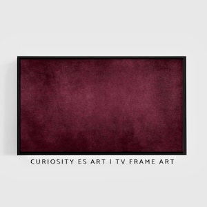Puede incluir: Una obra de arte abstracta enmarcada con una textura de terciopelo burdeos intenso. La obra está encerrada en un elegante marco negro. El texto en la parte inferior dice "CURIOSITY ES ART I TV FRAME ART".