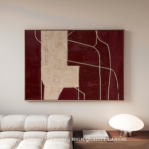 Puede incluir: Impresión artística abstracta con un fondo burdeos oscuro, una gran forma geométrica beige claro y finas líneas doradas. La obra de arte está enmarcada en madera natural e incluye el texto "CURIOSITY ES ART | HIGH QUALITY CANVAS".