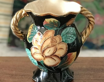 Hand-painted Vallauris ceramic vase decorated with multi-colored flowers on a black background, 1950s
