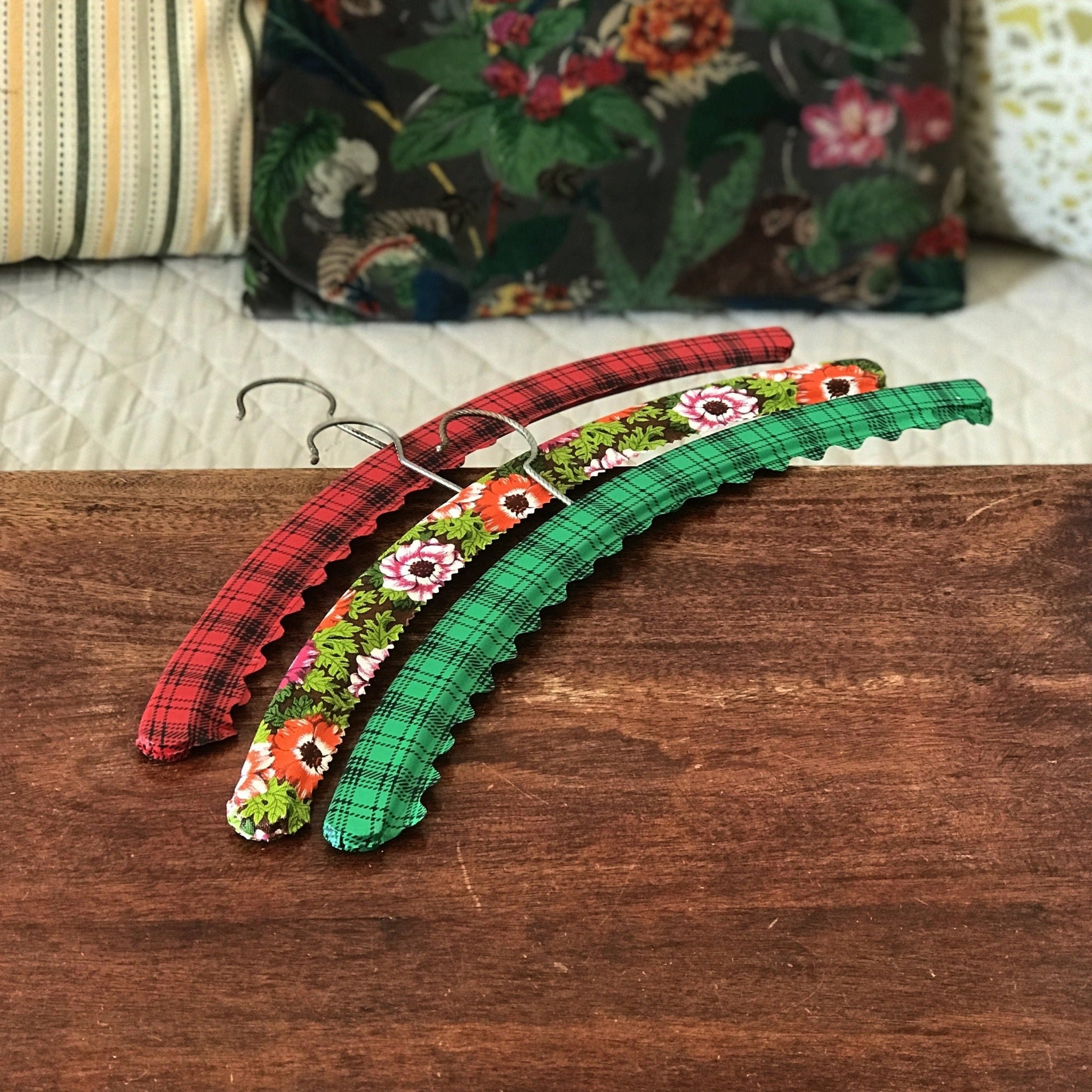 Set of 3 vintage hangers covered in floral and plaid vinyl