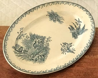 Oval earthenware serving platter from Pexonne, decorated with birds, dimensions 38 x 25 cm