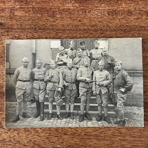 May include: A handmade wooden sign with the text "Welcome" in a handwritten style. The sign is painted white with a distressed finish, and a small, decorative heart is attached. The sign measures approximately 12 inches wide.