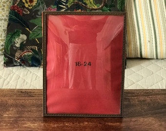 Rectangular photo frame with brass outline and curved glass