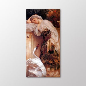 May include: A woman in a white dress with a gold and black sash leans against a stone wall. She is looking down at a white swan with its wings spread. The swan is standing on a stone ledge. The woman is holding a peacock feather fan.