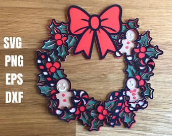 May include: A layered Christmas wreath design with a red bow, holly leaves, berries, gingerbread men, and candy canes. The wreath is in a circular shape with the text "SVG PNG EPS DXF" on the left side.