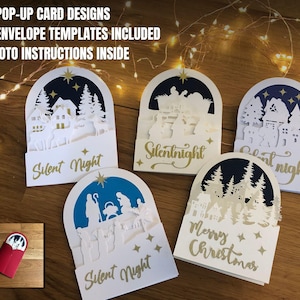 Op de afbeelding: Vijf pop-up kaartontwerpen met envelopsjablonen en foto-instructies. De kaarten tonen ingewikkelde uitgesneden ontwerpen van winterse taferelen en religieuze thema's, met de woorden "Silent Night" en "Merry Christmas".