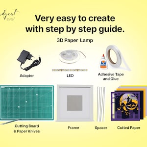 May include: An assortment of materials for a 3D paper lamp project, including an adapter, LED lights, adhesive tape and glue, a cutting board, paper knives, a frame, spacers, and cut paper. The text reads "Very easy to create with step by step guide."