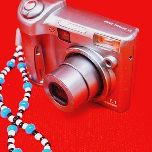 OLYMPUS SP-310 7.1MP Digital Camera with 3x Optical Zoom (Silver)