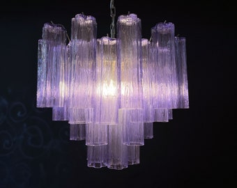 May include: A purple glass chandelier with multiple tiers of rectangular prisms. The chandelier is hanging from a chain.