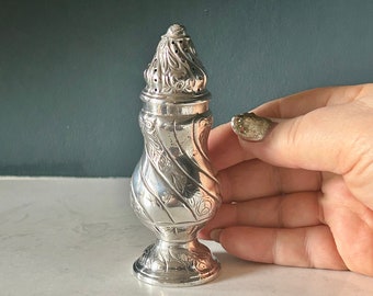 Antique stamped sterling silver rococo pepper shaker (10cm high x 4.5cm diameter)