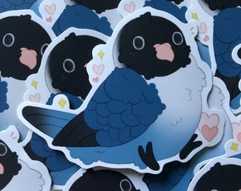 May include: A stack of blue and black bird stickers with pink hearts and sparkles. The birds have large eyes and a white belly.