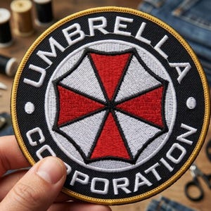 May include: Embroidered patch with the text "UMBRELLA CORPORATION" in white on a black background. The patch features a red and white umbrella logo in the center, with a yellow border. The patch is round.