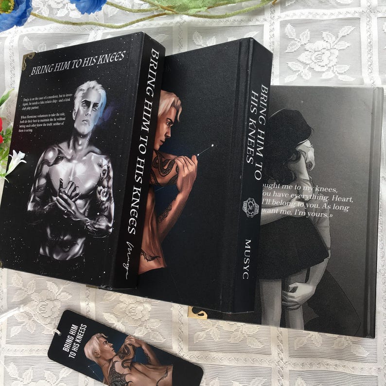 May include: Three books are stacked, with the title "Bring Him to His Knees" on the spines. The covers display illustrations of figures with tattoos. A bookmark with the same title and image is also visible.