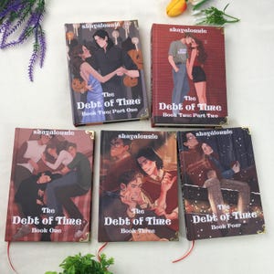 May include: Five books with illustrated covers are displayed. The books, titled "The Debt of Time," feature various couples and scenes. The covers are predominantly brown and red, with gold corner accents. The author's name, "shayalonnie," is printed at the top of each book.