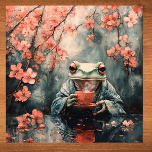 May include: A green frog wearing a blue and white robe sits in front of a pink and white floral background. The frog is holding a red teacup with steam rising from it.