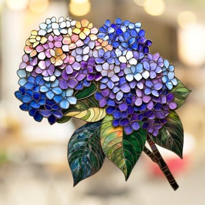 May include: A stained glass hydrangea flower with blue, purple, and pink petals. The leaves are green with a detailed vein pattern.