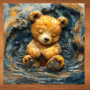 May include: A small, brown teddy bear with closed eyes is lying on a blue and gold textured surface. The bear is made of a soft, plush material and has a sweet, innocent expression.