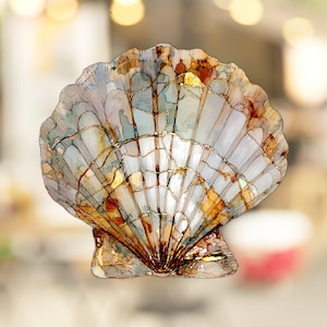 May include: A detailed illustration of a seashell with a white, blue, and brown color scheme. The shell has a textured surface and intricate details.