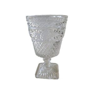 May include: A clear glass goblet with a square base and a diamond pattern. The goblet is made of thick glass and has a classic design.