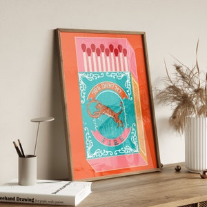 May include: A vintage-style matchbox illustration with a tiger jumping through a ring of fire. The text on the box reads "You light my fire".