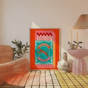 May include: A vintage-style illustration of a matchbox with a tiger jumping through a ring of fire. The matchbox is red, pink, and blue with the text "You light my fire" on the front.