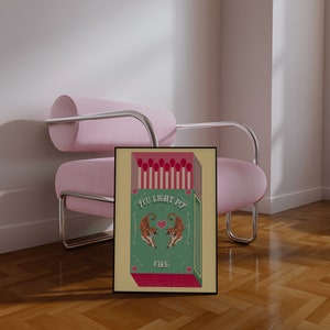 May include: A green and yellow matchbox with a red heart and two orange tigers. The text on the matchbox reads "You light my fire."