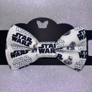 May include: White bow tie with a black and white Star Wars print featuring the words "Star Wars" and images of R2-D2 and BB-8.