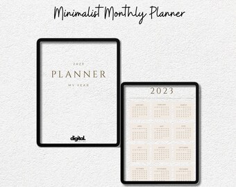 Könnte beinhalten: Zwei digitale Planer mit schwarzen Rahmen, einer mit der Aufschrift "2023 PLANNER MY YEAR" und der andere mit einem Kalender für 2023. Ein weißer Stift liegt darunter. Der Text "Minimalist Monthly Planner" steht oben.