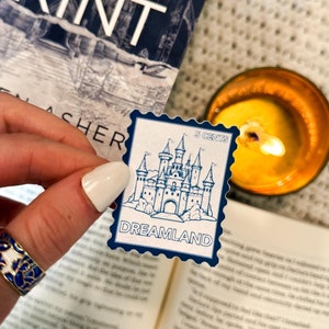 May include: A blue and white sticker with a castle illustration and the text "Dreamland" and "5 Cents".
