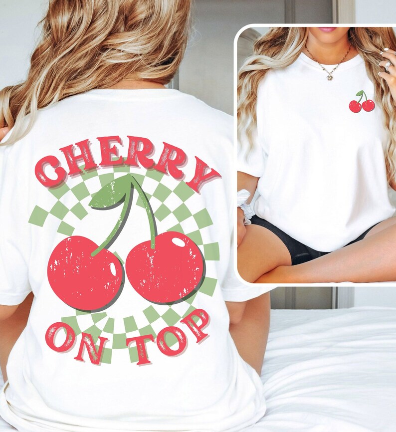 May include: White t-shirt with a red and green cherry graphic and the text "CHERRY ON TOP" printed on the back.