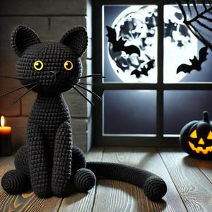 黄色い目をした黒いかぎ針編みの猫 – ハロウィーンの編みぐるみのデコレーションパターン – 光る目をした長い尻尾の黒猫