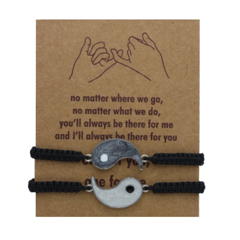 May include: Two black friendship bracelets with yin yang charms. The card reads: "no matter where we go, no matter what we do, you'll always be there for me and I'll always be there for you".