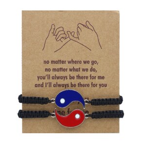 May include: Two black friendship bracelets with yin yang charms. The charms are silver with blue and red enamel. The bracelets are tied together with a knot. The card reads: "no matter where we go, no matter what we do, you'll always be there for me and I'll always be there for you."