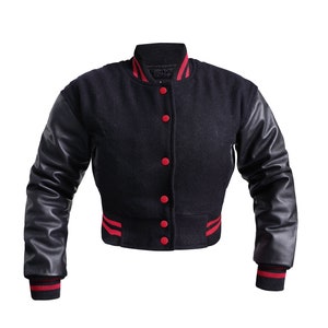 May include: A black varsity jacket with red and white stripes on the cuffs and bottom. The sleeves are made of black leather.
