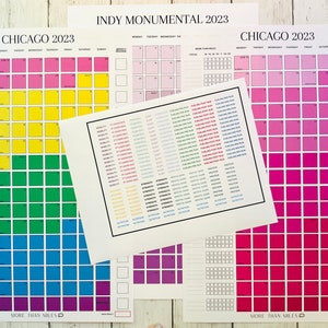 May include: Three printable calendars with a rainbow color scheme. The calendars are titled "Chicago 2023", "Indy Monumental 2023", and "Chicago 2023". Each calendar has a grid of squares with days of the week labeled at the top. The calendars are designed for tracking fitness goals.