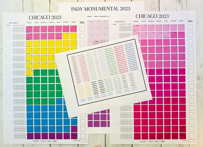 May include: Three printable calendars with a rainbow color scheme. The calendars are titled "Chicago 2023", "Indy Monumental 2023", and "Chicago 2023". Each calendar has a grid of squares with days of the week labeled at the top. The calendars are designed for tracking fitness goals.