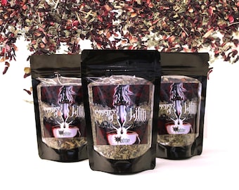 May include: Three black resealable pouches with a white label that says "Essence of Lilith" in a gothic font. The pouches contain loose leaf tea.