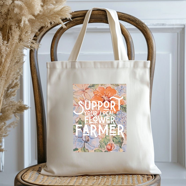 May include: A white canvas tote bag with a floral design and the text "SUPPORT YOUR LOCAL FLOWER FARMER".
