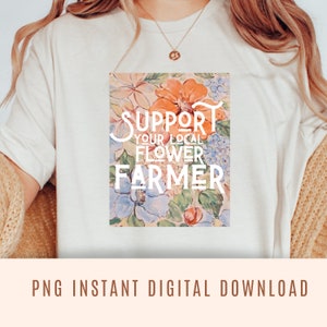May include: White t-shirt with a floral design and the text "SUPPORT YOUR LOCAL FLOWER FARMER" printed on the front.