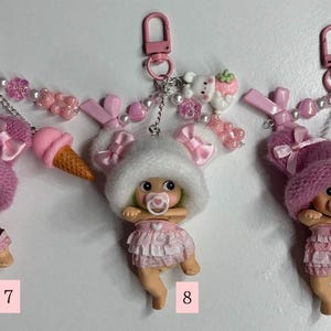 May include: A white ceramic mug with a black handle and the text "But First, Coffee" in a black, handwritten-style font. The mug is on a white surface.