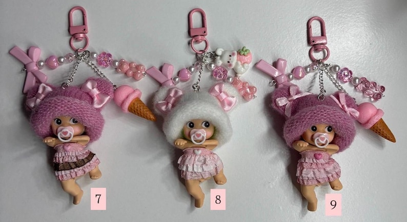 May include: A white ceramic mug with a black handle and the text "But First, Coffee" in a black, handwritten-style font. The mug is on a white surface.