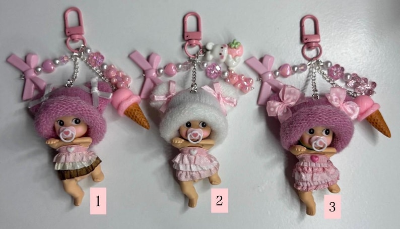 May include: A white ceramic mug with a black handle and the text "But First, Coffee" in a black, handwritten-style font. The mug is on a white surface.