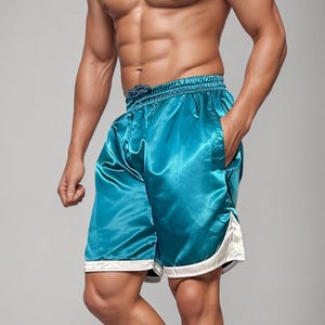 May include: Teal satin shorts with white trim. The shorts feature a drawstring waist and pockets. The fabric has a shiny appearance. The shorts are knee-length and appear to be athletic wear.