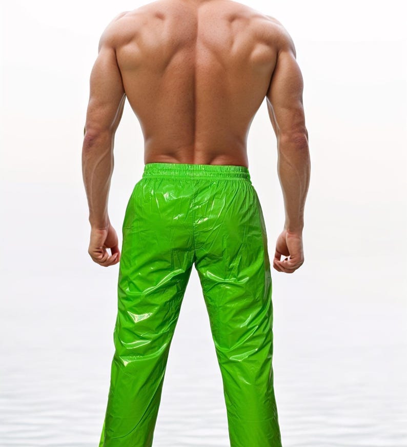 May include: Bright lime green pants with a glossy, reflective finish and an elasticized waistband. The pants feature a straight-leg cut and a smooth, synthetic-looking material that catches the light, creating distinct highlights and shadows.